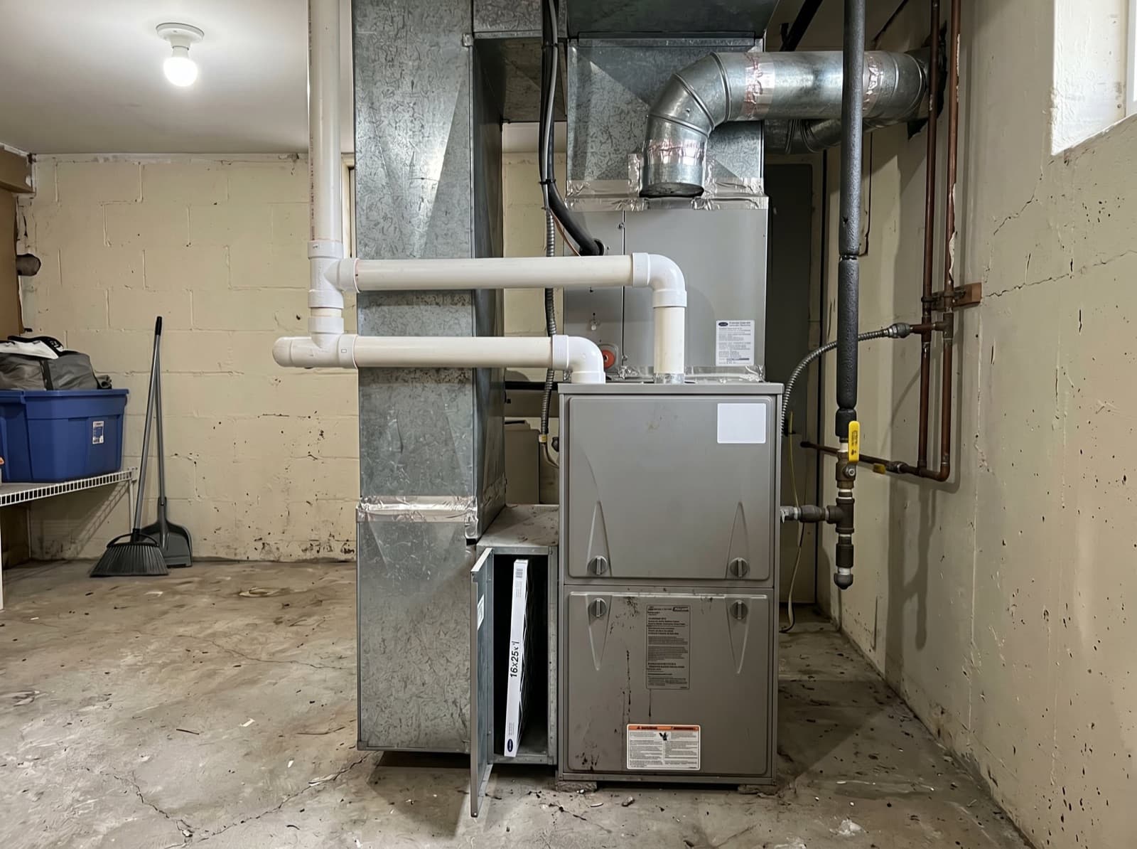 Basement utility room with furnace and ductwork.