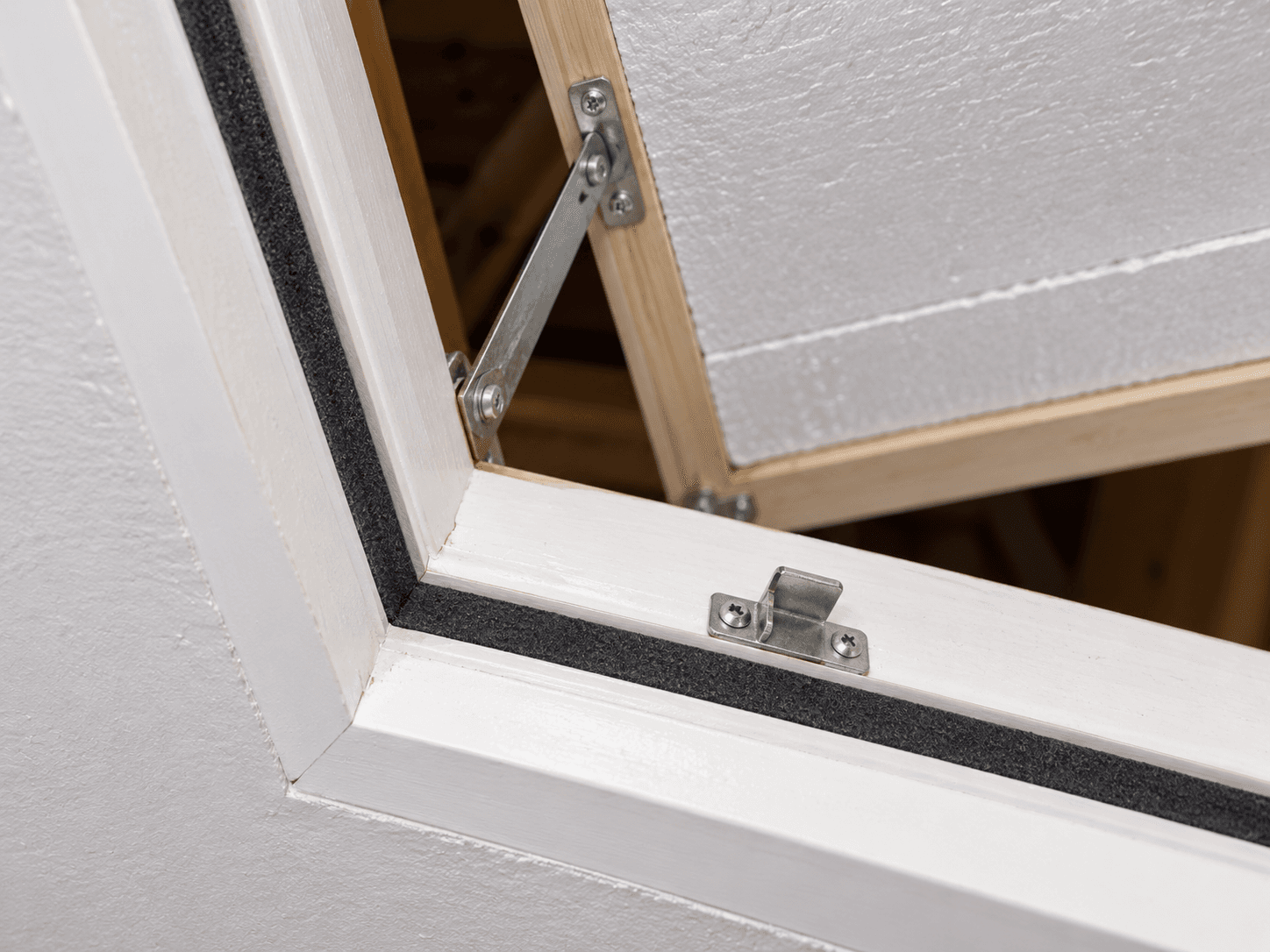 A close view of a hatch frame shows a continuous compressible seal and its latch contact.