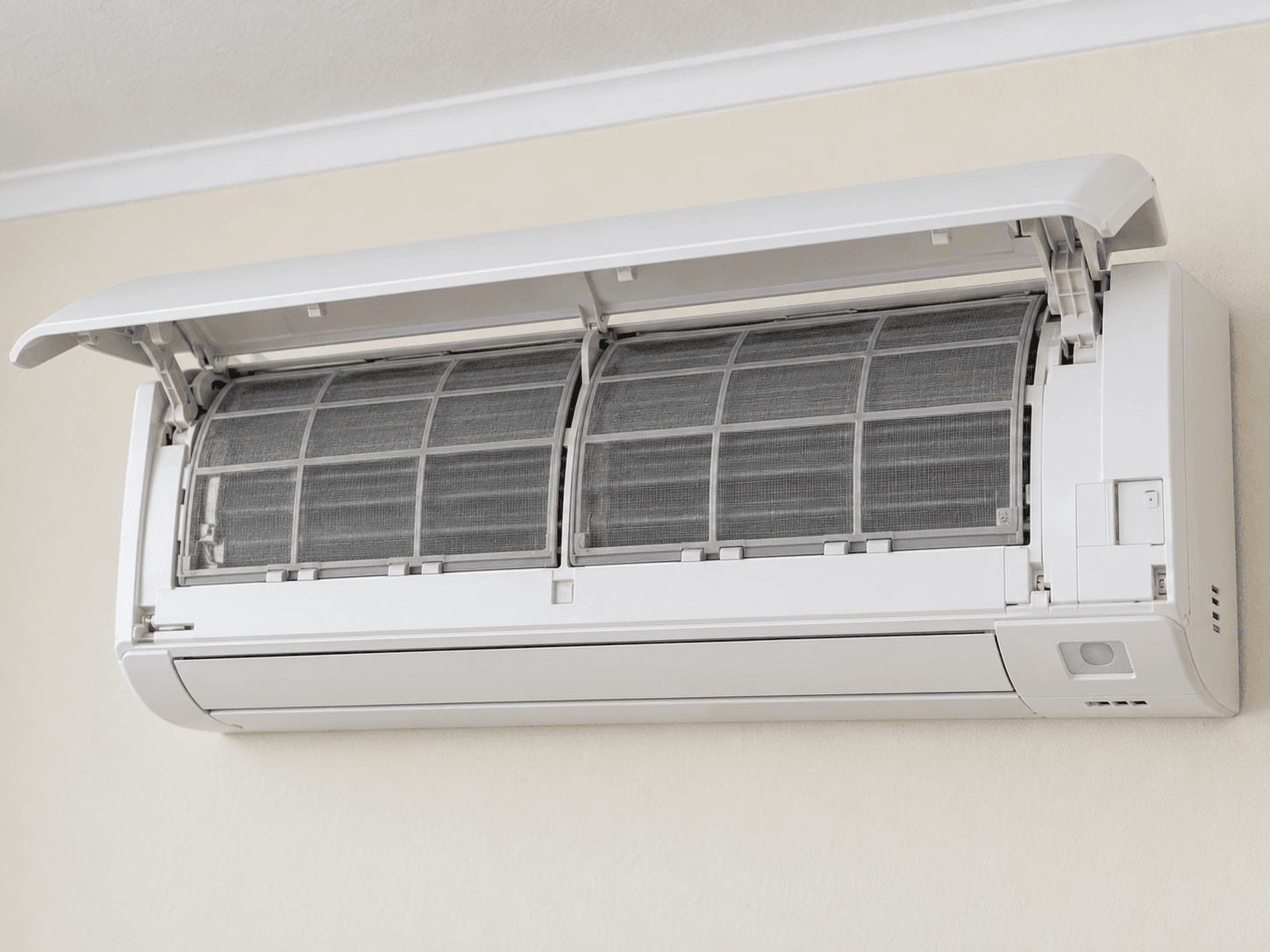The owner-access front panel is open above fitted mesh filters.